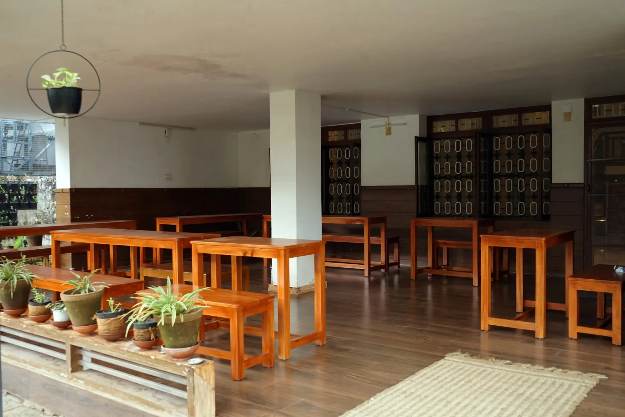 A covered veranda with tables and benches